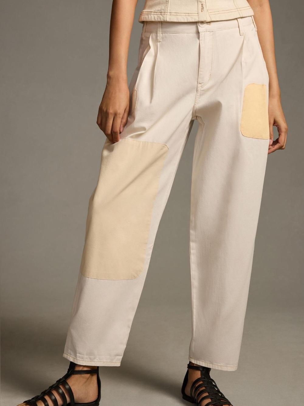 Anthropologie Pilcro tolled hem utility barrel pants in beige with patches.